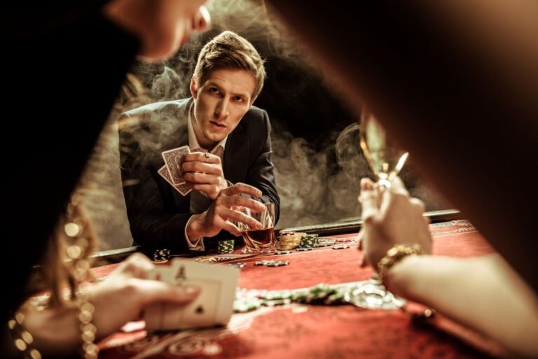 concentrated-man-with-drink-and-poker-cards